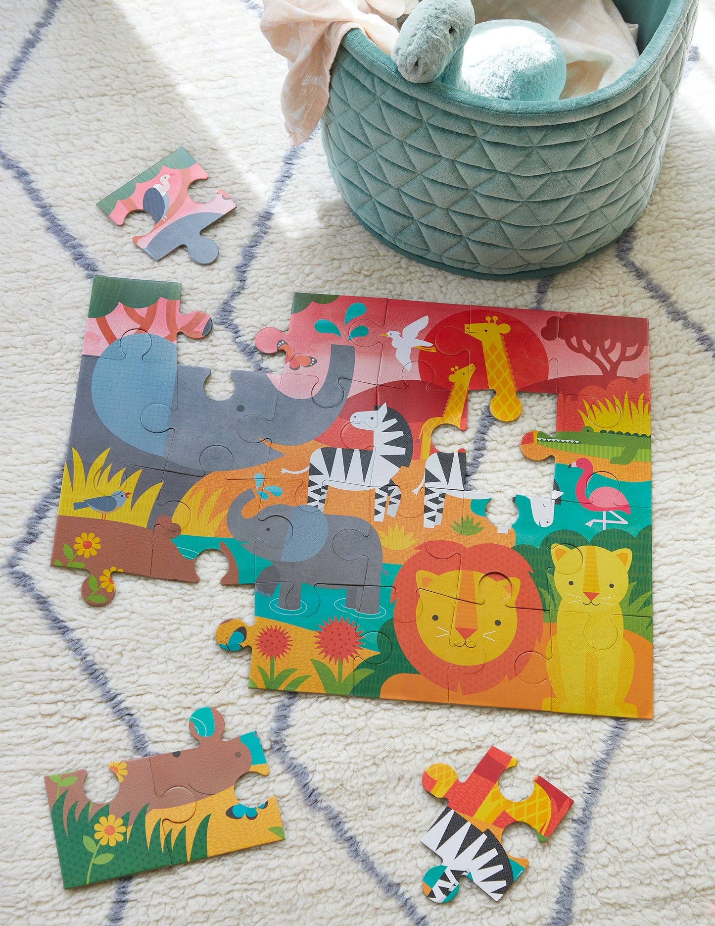 Children's animal-themed puzzle on a carpeted floor with a basket in the background
