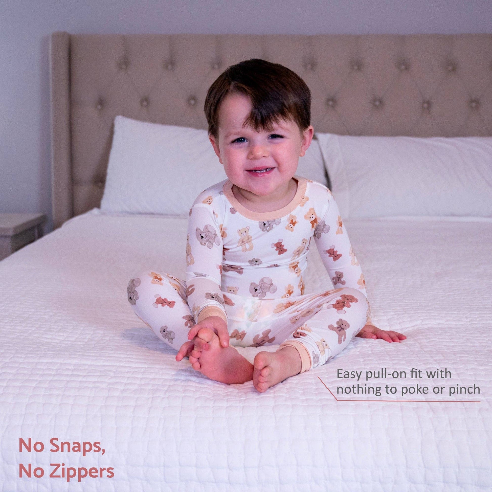 Child wearing patterned pajamas sitting on a bed with text about the garment's features.