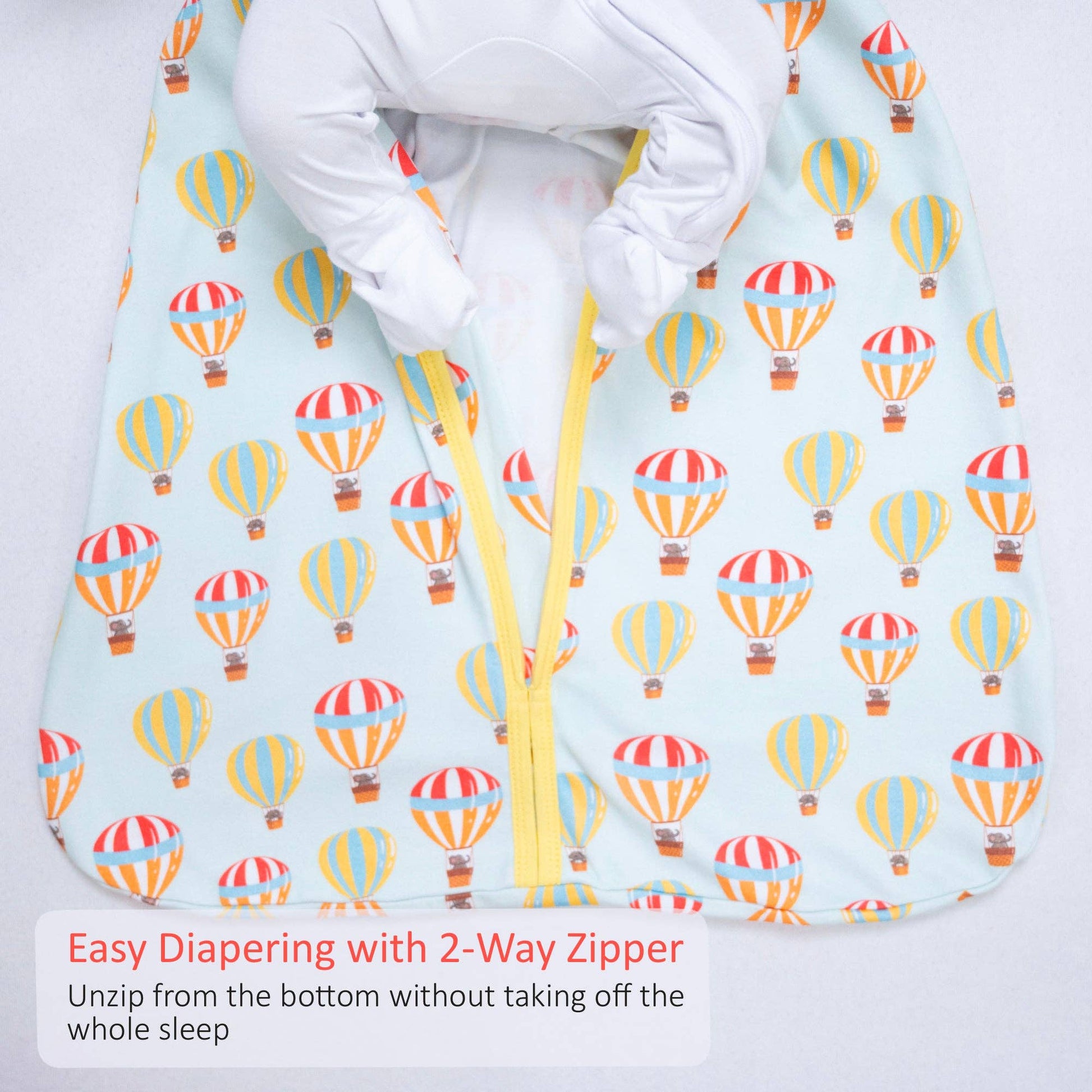 Baby sleeping sack with hot air balloon pattern and 2-way zipper on a light blue background.