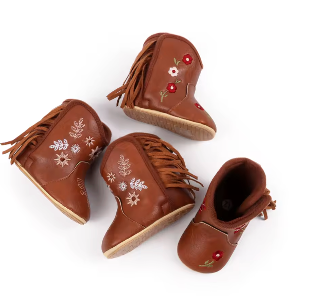 Set of brown children's boots with floral embroidery on a white background
