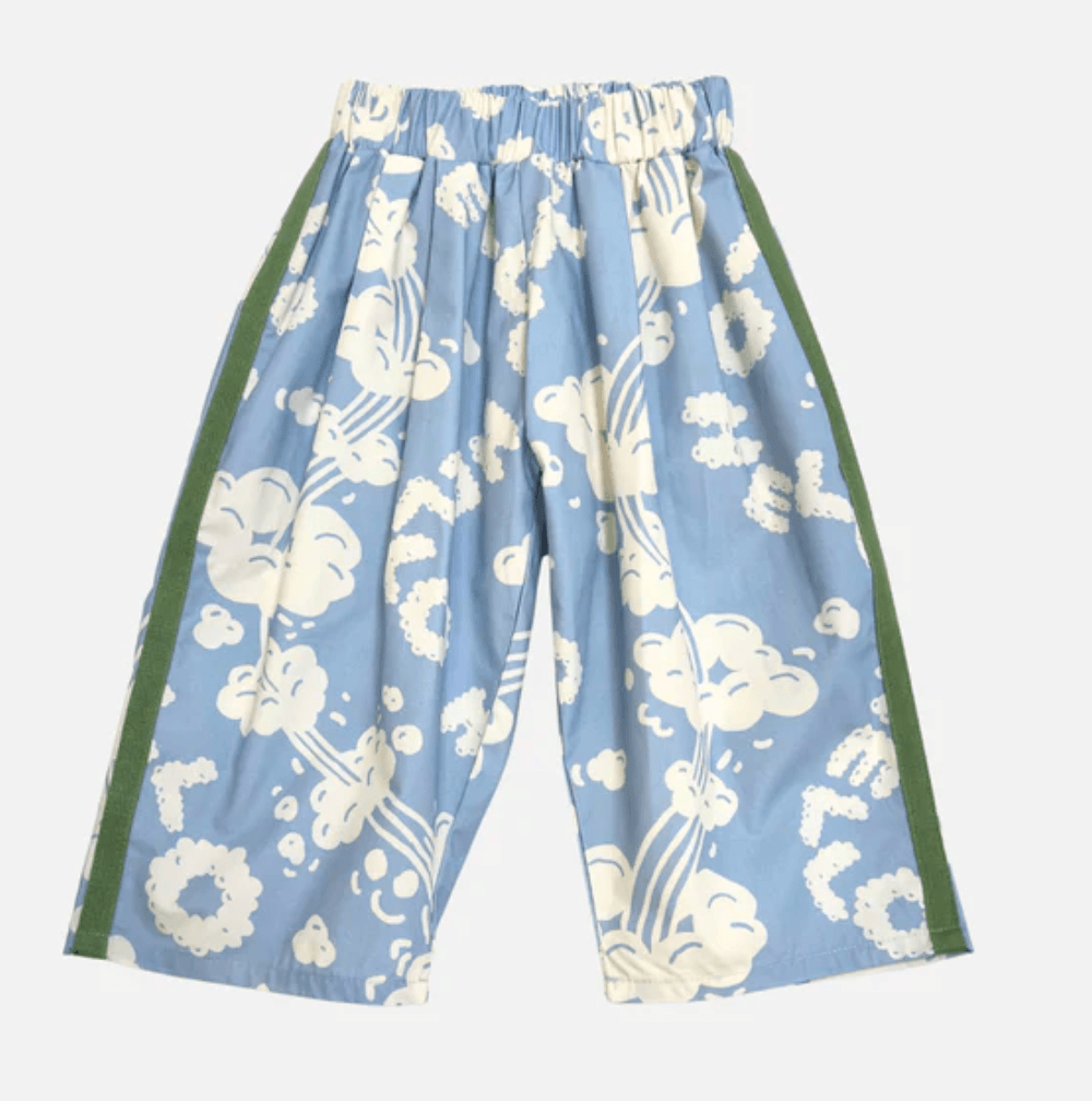 Blue floral-patterned pants with green accents on a white background