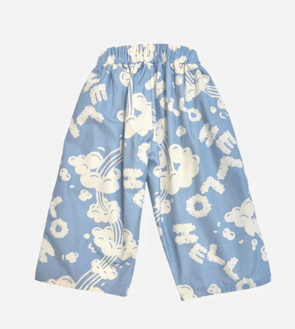 Light blue pants with white cloud and 'HELLO' pattern on a light gray background