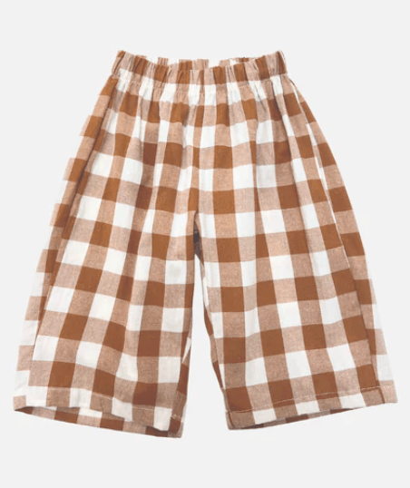 Plaid toddler pants with brown and white check pattern on a light gray background