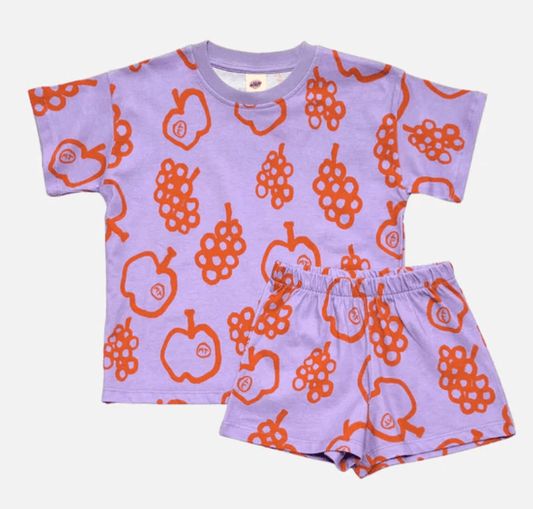 Children's t-shirt and shorts set with orange fruit pattern on a light purple background
