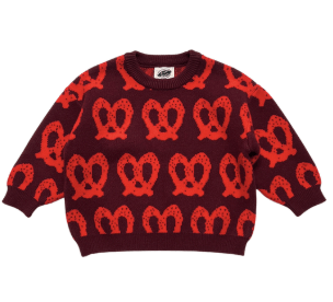 A long-sleeve crewneck sweater featuring an all-over pattern of red pretzels on a dark burgundy background, displayed flat against a white background.