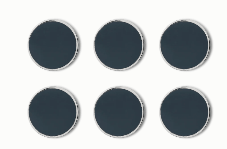 Six round dark gray magnets with silver borders arranged in two rows of three on a white background.