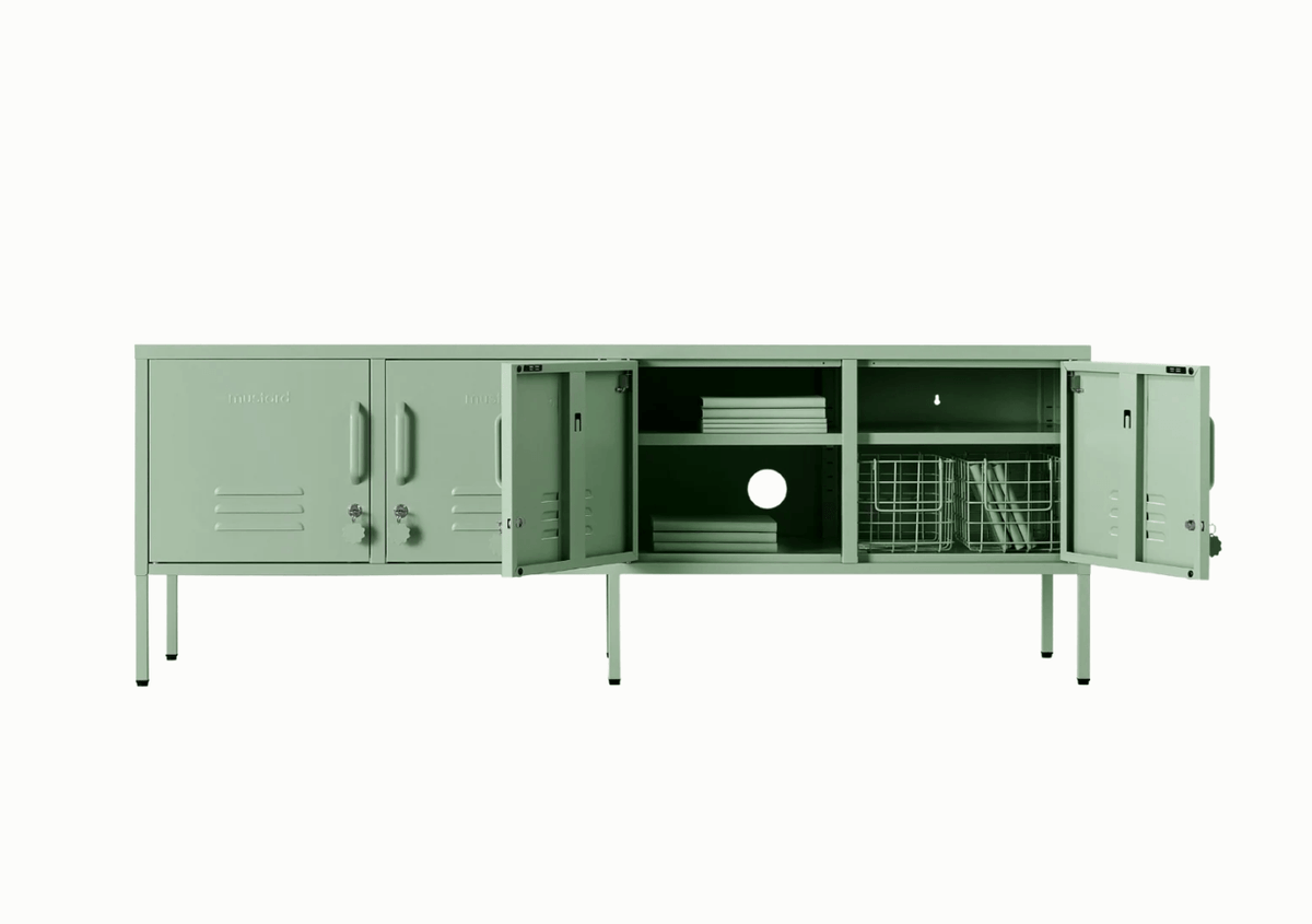 Green locker-style cabinet on a white background with four doors. Two doors are open showing green contents such as books and wire baskets arranged on the shelves.
