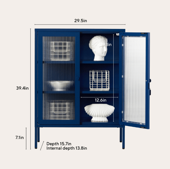 A navy blue cabinet with glass doors and white interior shelving, shown with dimension labels for height, width, depth, and internal depth. White decorative baskets and a bust on one shelf are included in the product presentation.