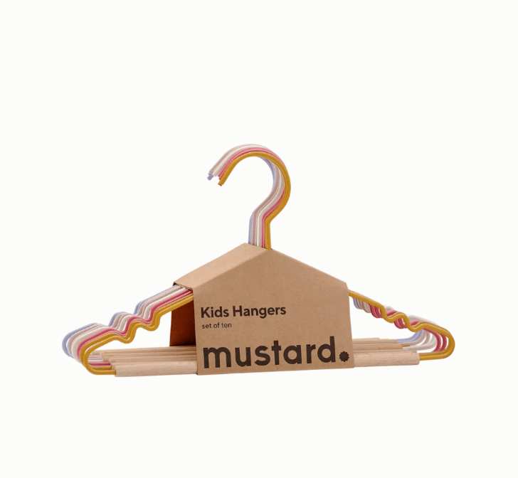 A set of five colorful kids hangers with colorful pastel metal wire frames, packaged in a cardboard house-shaped sleeve printed with the brand name 'mustard.' and product type 'Kids Hangers set of five.