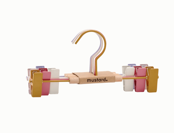 Metal pants hanger with a central wooden bar branded 'mustard.' in black lowercase text.