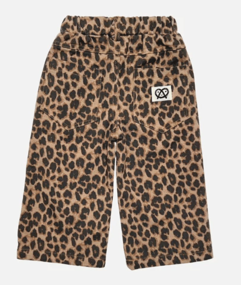 A pair of toddler's wide-leg trousers featuring a brown and black leopard print pattern, a drawstring waist, and a small white brand patch on the right hip.