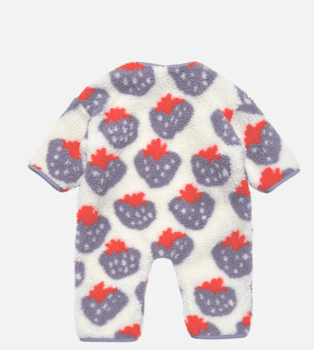 A white fleece baby romper with a repeating pattern of purple strawberries with red tops, shown against a light gray background.