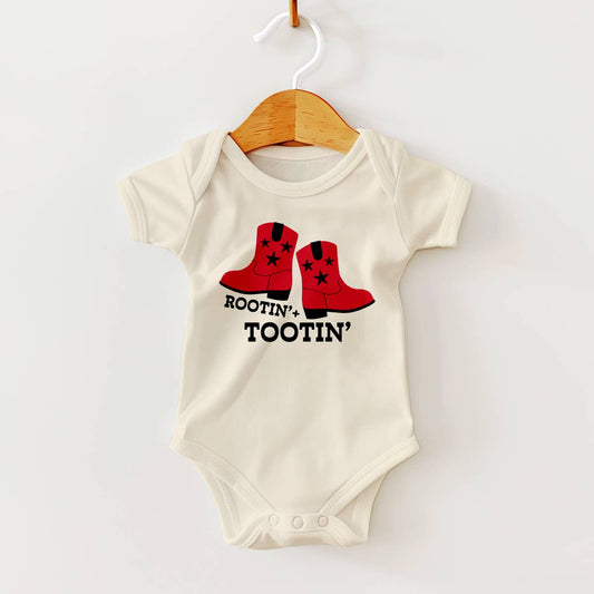 Baby onesie with red boots and 'Rootin' Tootin'' text on a white background