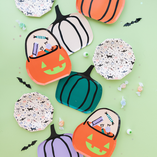 Halloween-themed coasters with pumpkins and candy bags on a green background