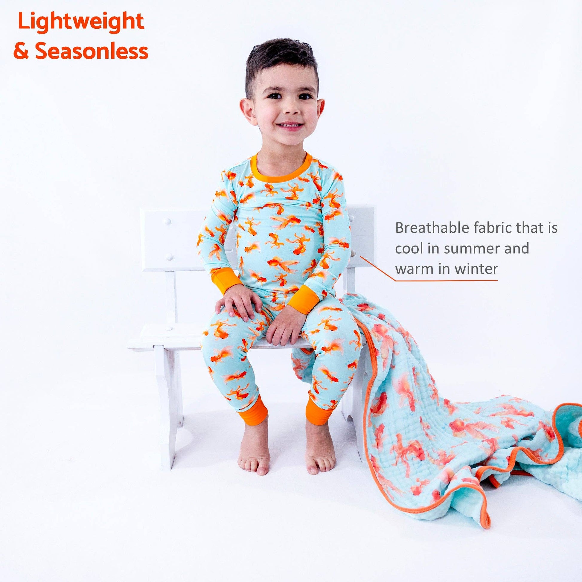 Child wearing a colorful outfit with a blanket, sitting on a white bench.