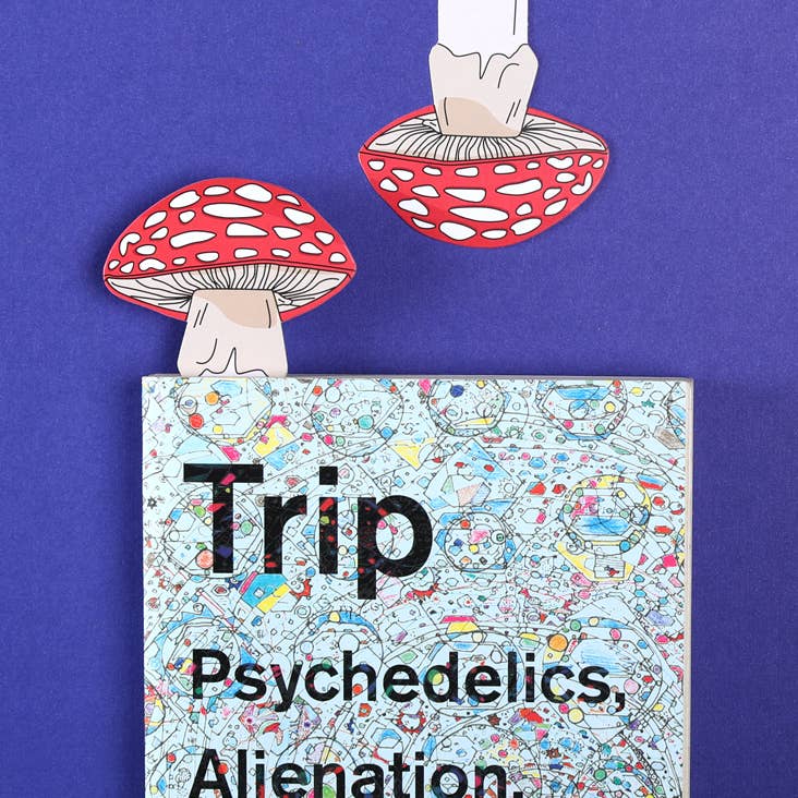 Book titled 'Trip: Psychedelics, Alienation' with illustrations of mushrooms on a purple background