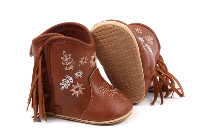 Brown children's boots with floral embroidery and fringes on a white background