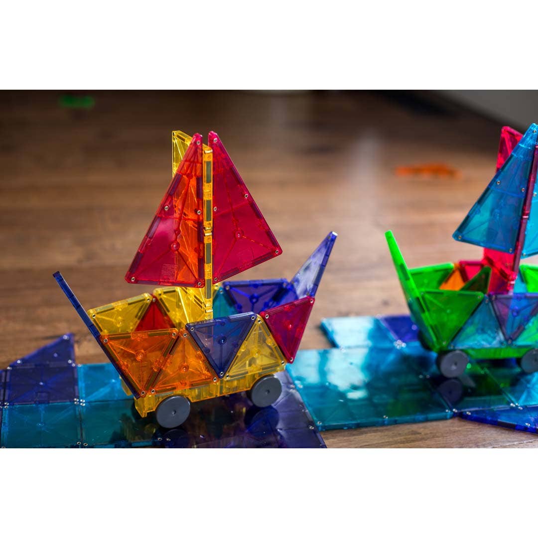 Colorful magnetic sailboat toys on a wooden surface