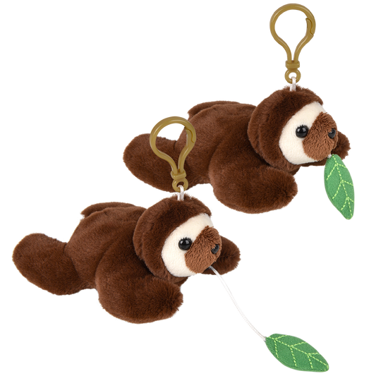 Two small plush sloth keychains on a plain white background. Each sloth is brown with a white face and holds a green leaf, attached to a gold-tone clip.