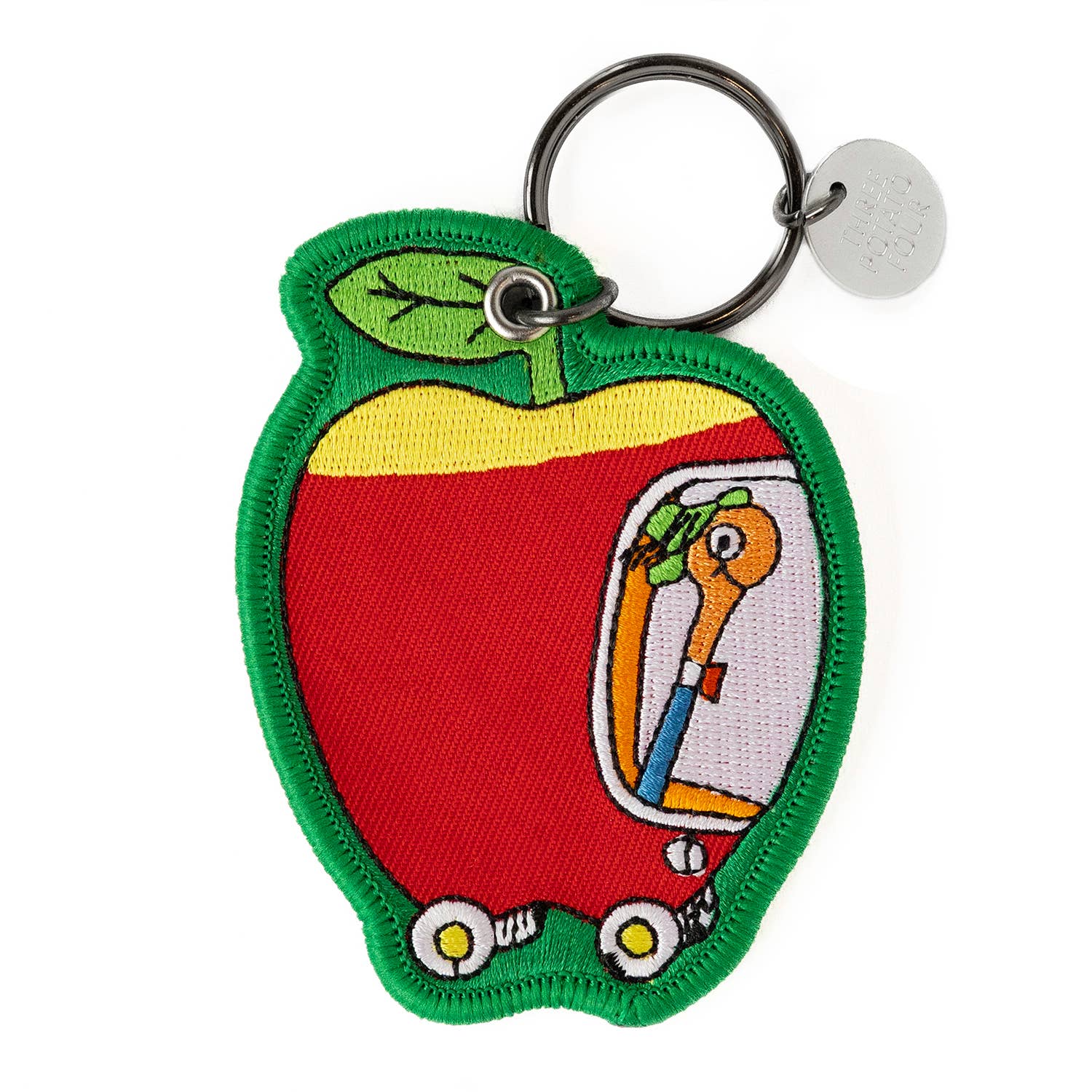 Keychain shaped like a red apple with a cartoon character inside on a white background