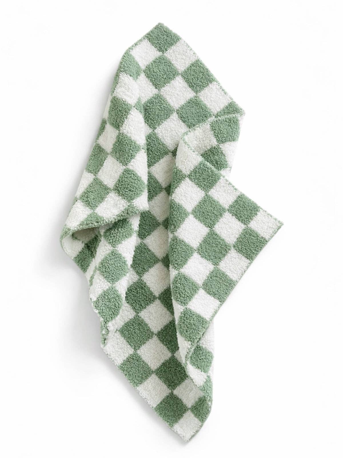 Green and white checkered baby blanket on a white background