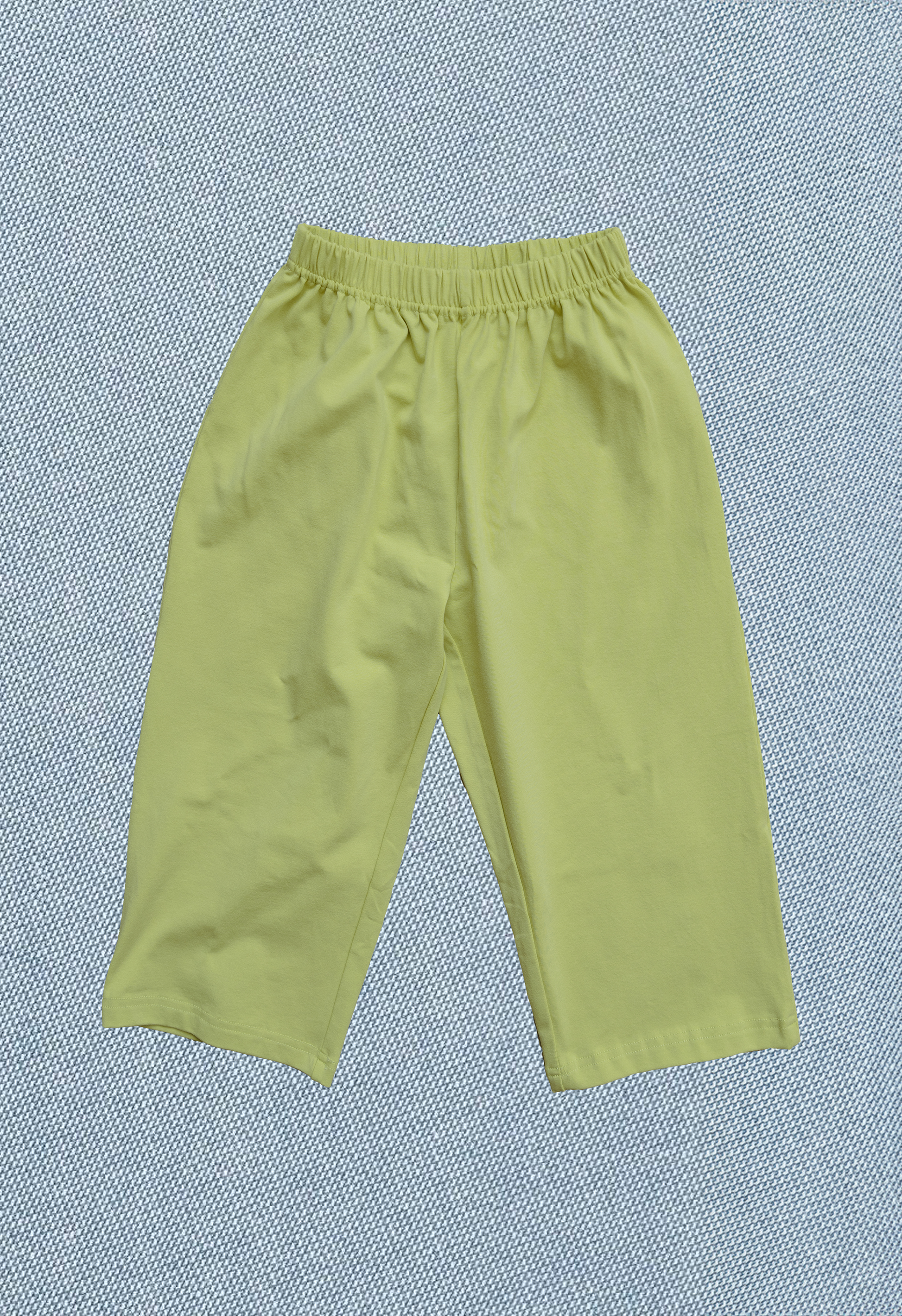 Green pants on a textured blue background