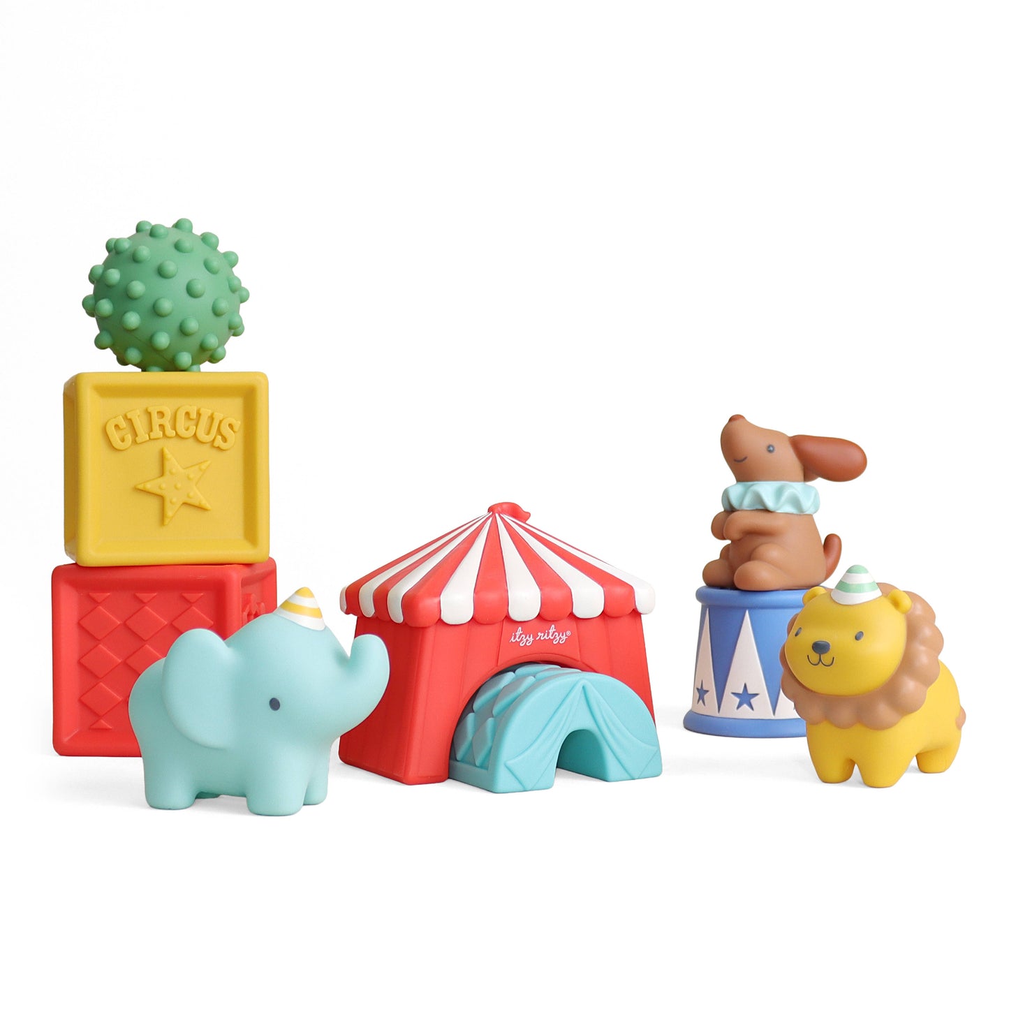 A set of colorful baby bath toys shaped like circus-themed objects, including a green spiky block labeled CIRCUS, a yellow block, a red block, a light blue elephant, a red and white striped tent, a blue and white striped bucket with a brown dog figure, and a yellow lion figure, all on a white background.