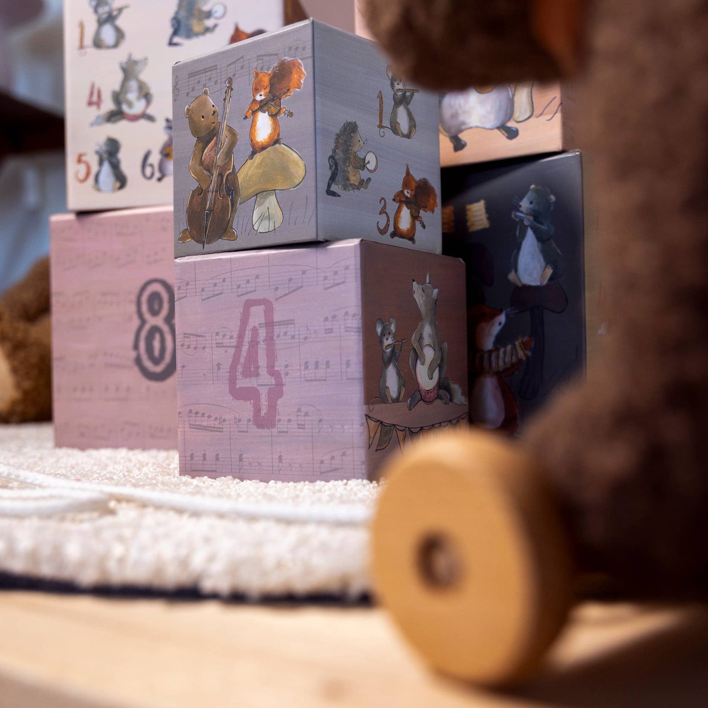 coated paper blocks with animal illustrations and numbers on a soft surface.