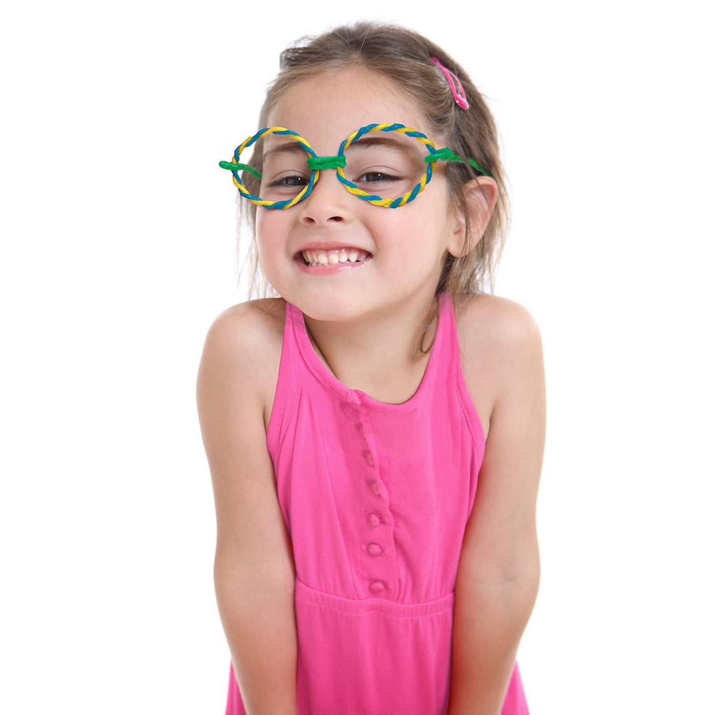 Young girl wearing colorful glasses and a pink dress on a white background