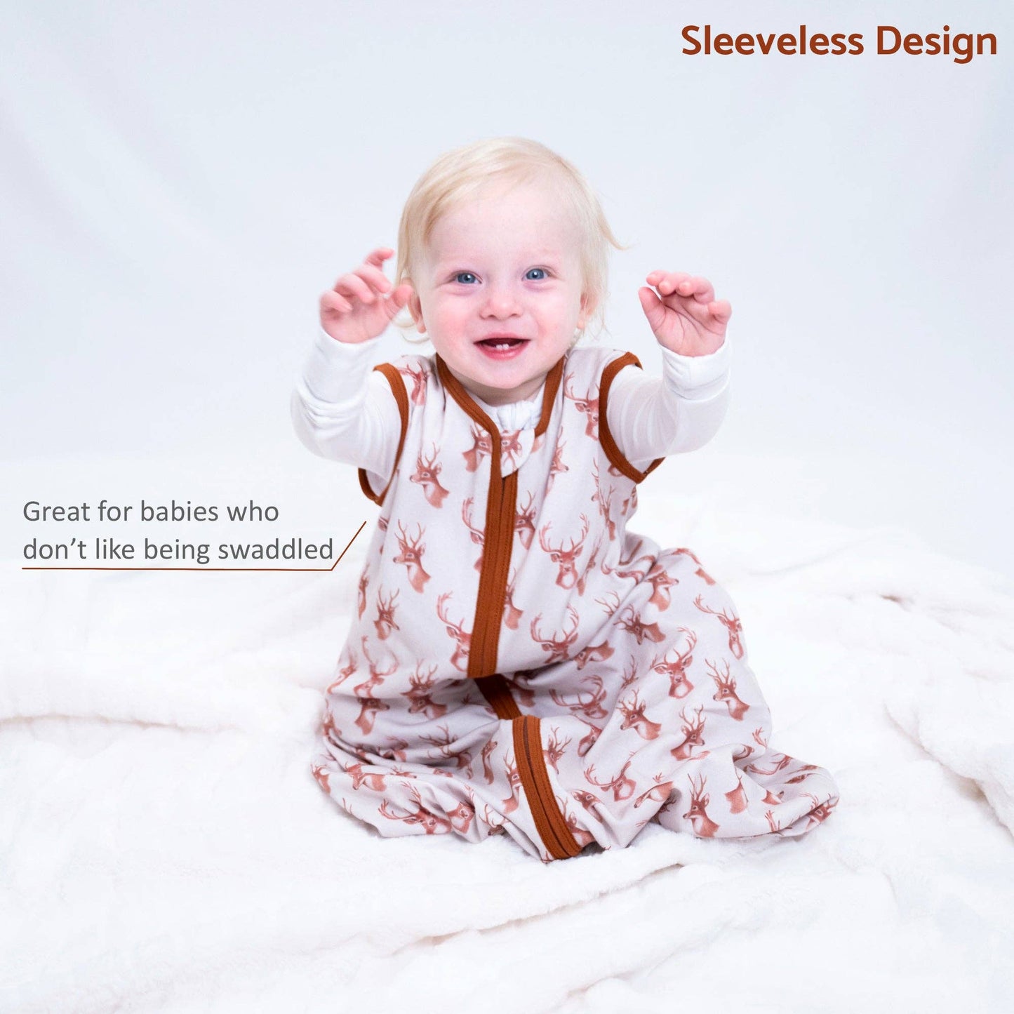 Baby wearing a sleeveless sleeping sack with deer pattern on a white background