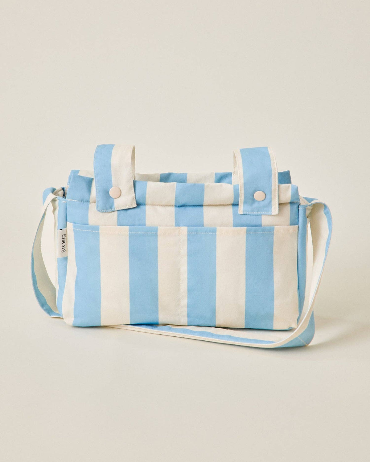 Blue and white striped bag on a beige background
