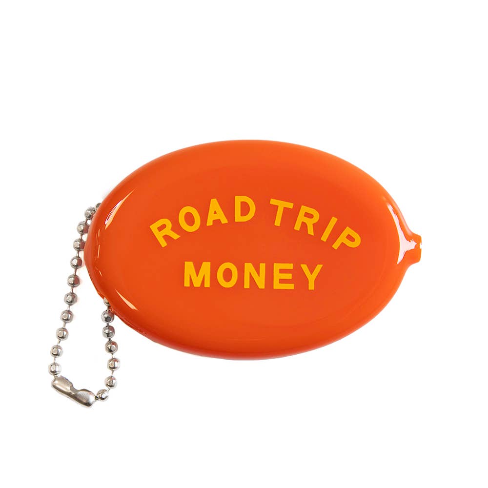 An orange oval-shaped coin purse with the words 'ROAD TRIP MONEY' printed in yellow on the front, attached to a silver ball chain, shown on a plain white background.