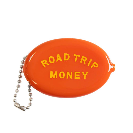An orange oval-shaped coin purse with the words 'ROAD TRIP MONEY' printed in yellow on the front, attached to a silver ball chain, shown on a plain white background.