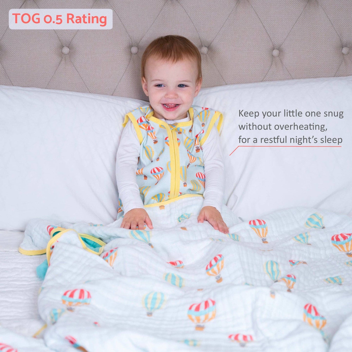 Child in a colorful sleeping sack and blanket with hot air balloon print all over with text about temperature rating and comfort.