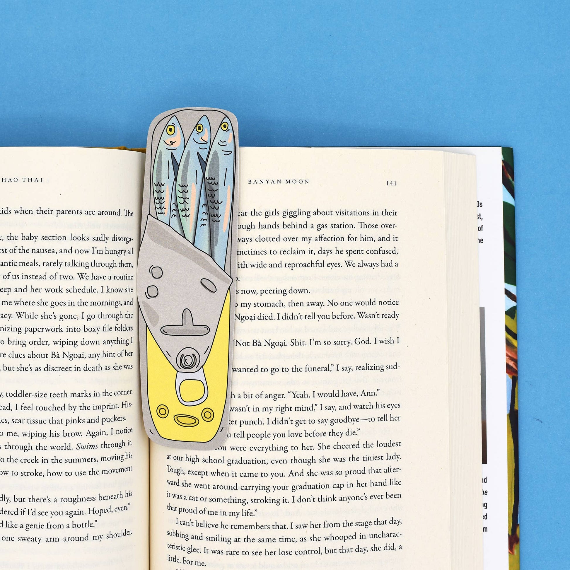 Book with a unique bookmark featuring fish illustrations on a blue background