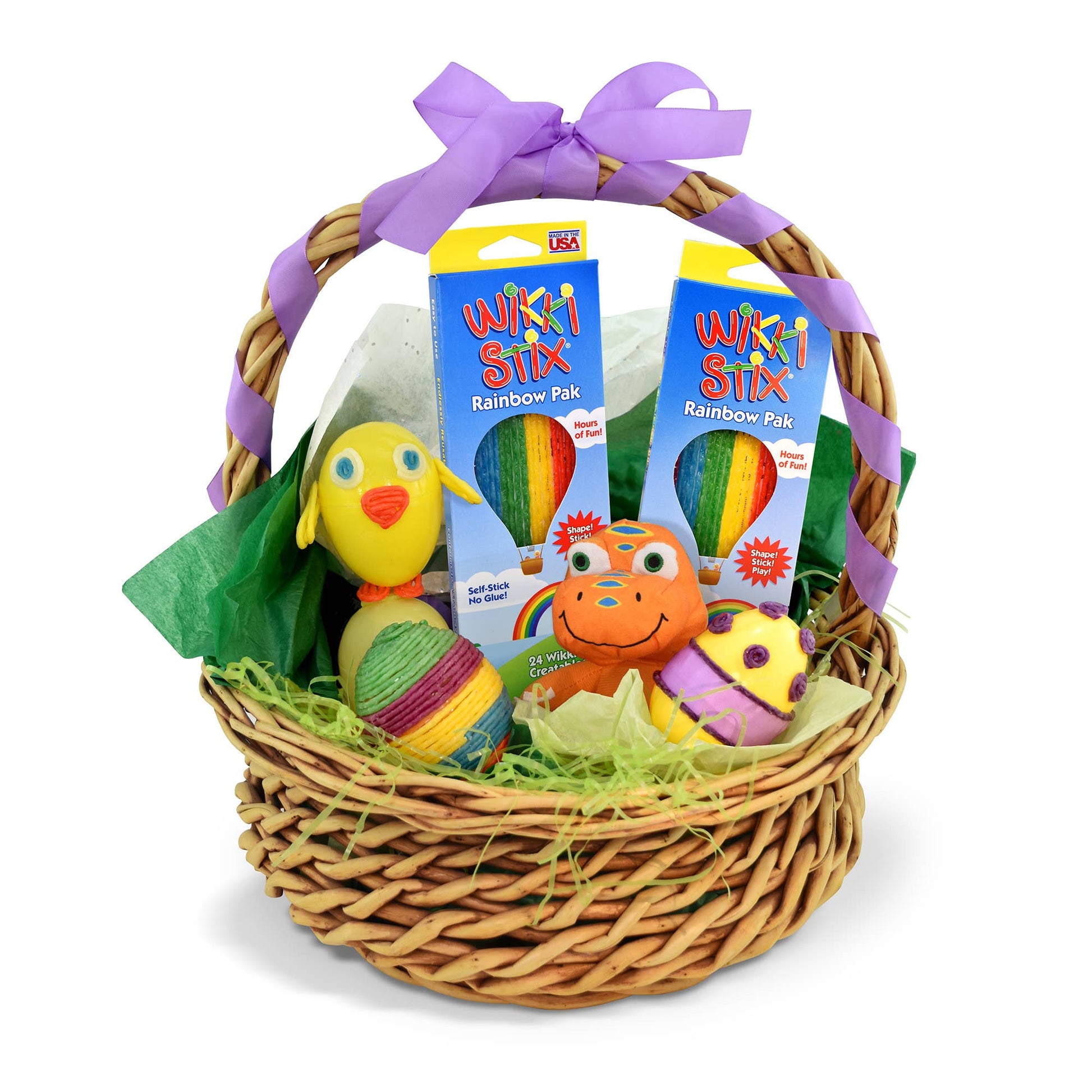 Wicker basket with toys and Wikki Stix packaging on a white background
