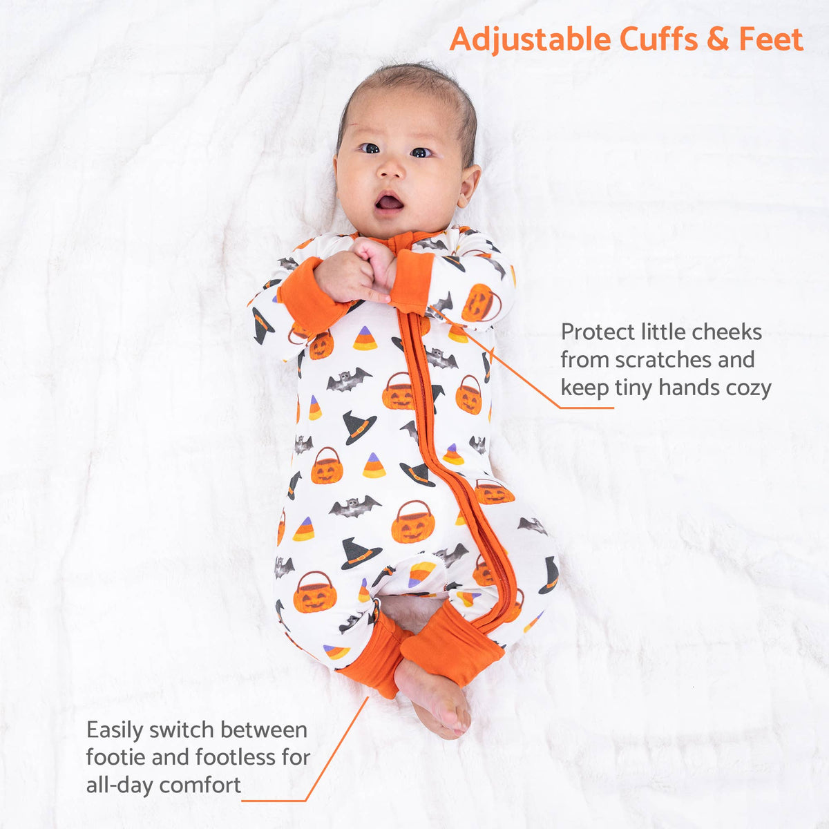 A baby lying on a white blanket wearing a white footless sleeper with orange trim and a Halloween print of pumpkins, ghosts, and candy corn. Text overlays describe the adjustable cuffs and feet and highlight safety features.
