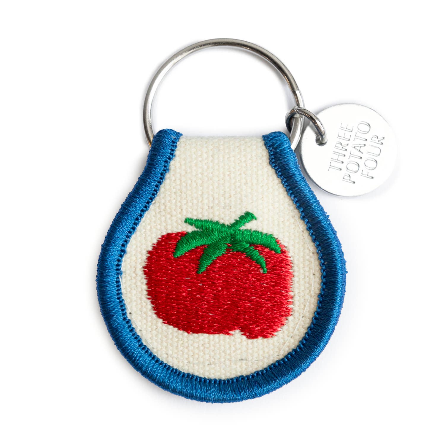 Keychain with embroidered tomato design on a white background