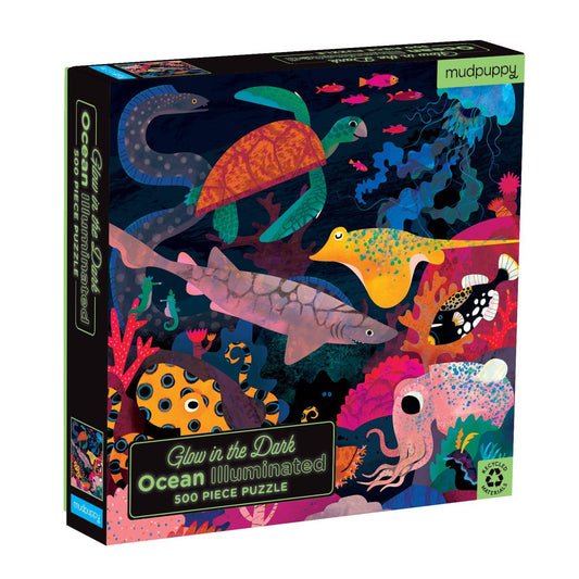 Glow-in-the-dark ocean-themed puzzle packaging with colorful sea creatures on a black background.