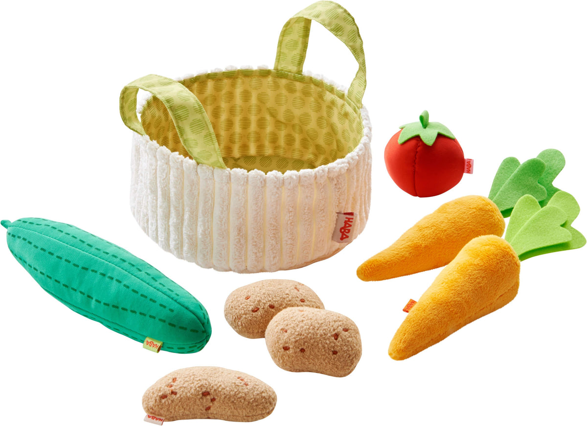 Set of toy vegetables and a basket on a white background