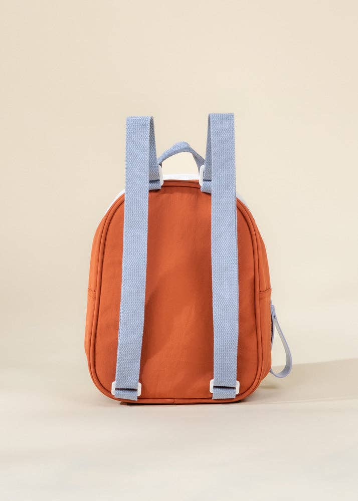 Orange backpack with blue straps on a beige background