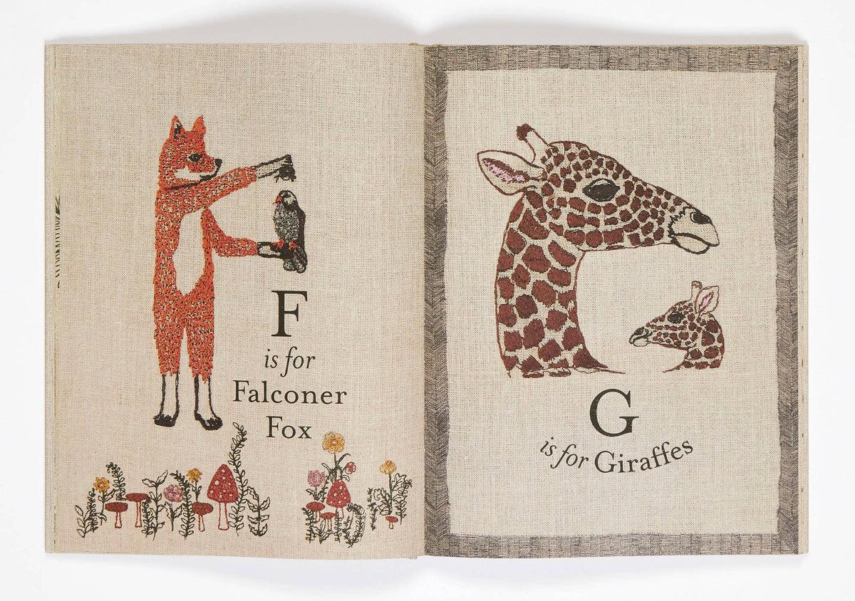 Children's book with illustrations of a falconer fox and a giraffe, each with corresponding letters on a textured beige background.