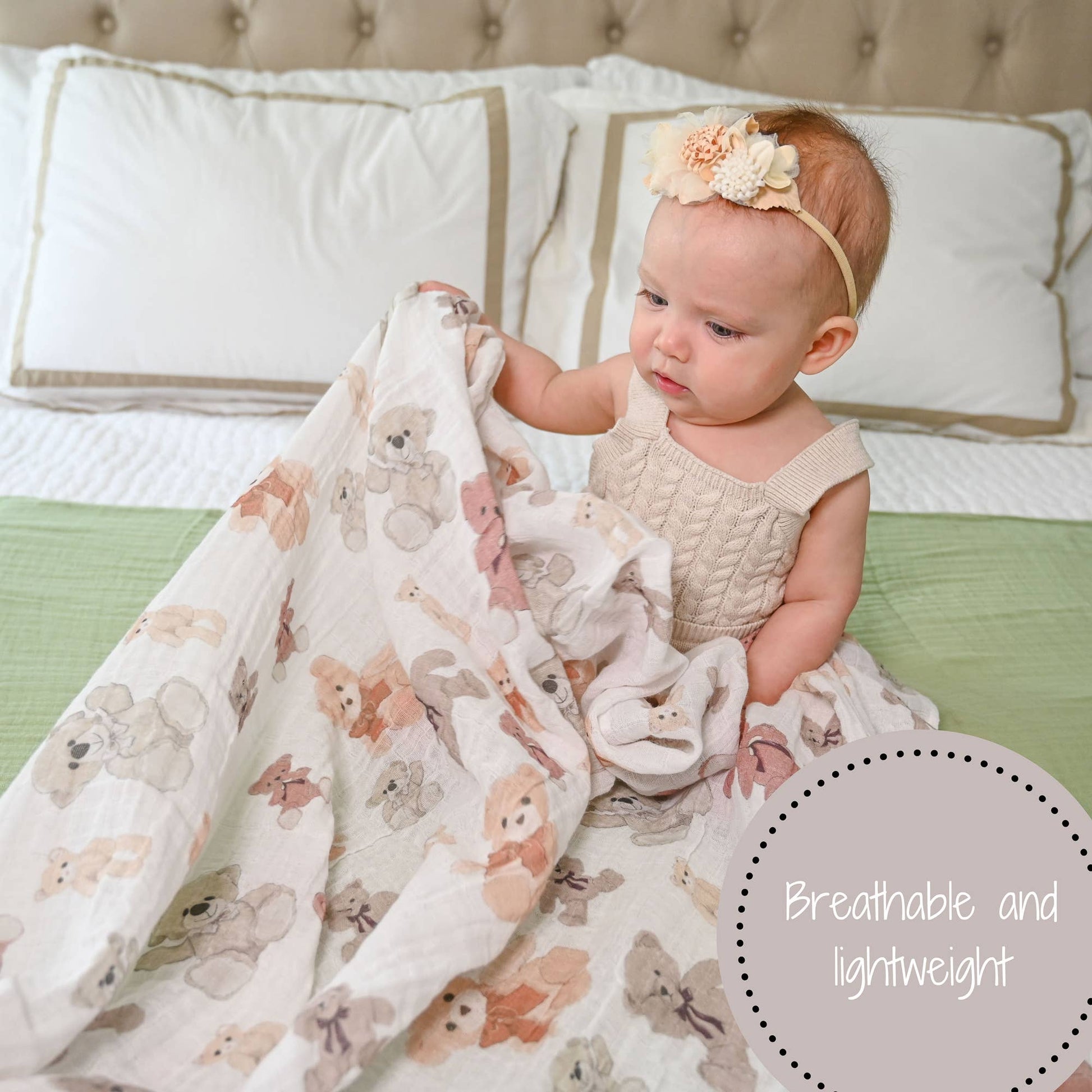 Baby holding a floral blanket on a bed with text 'Breathable and lightweight'.
