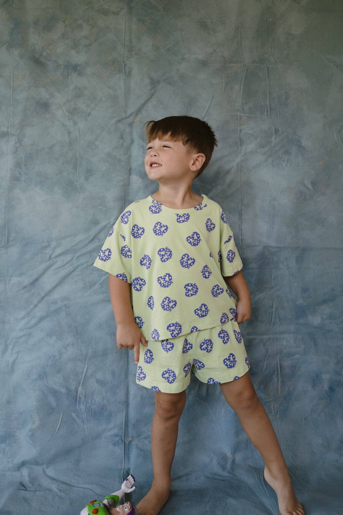 Child wearing a pretzel outfit against a textured gray background