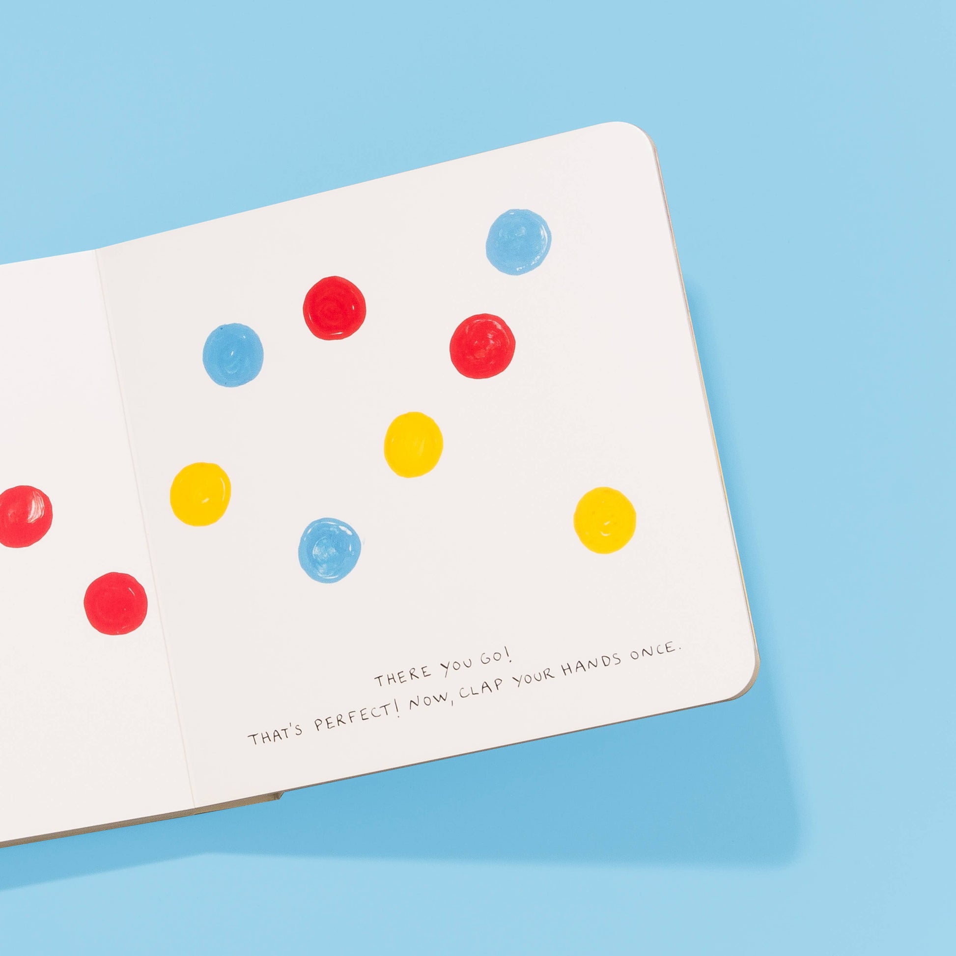 Board book with colorful polka dots on a blue background