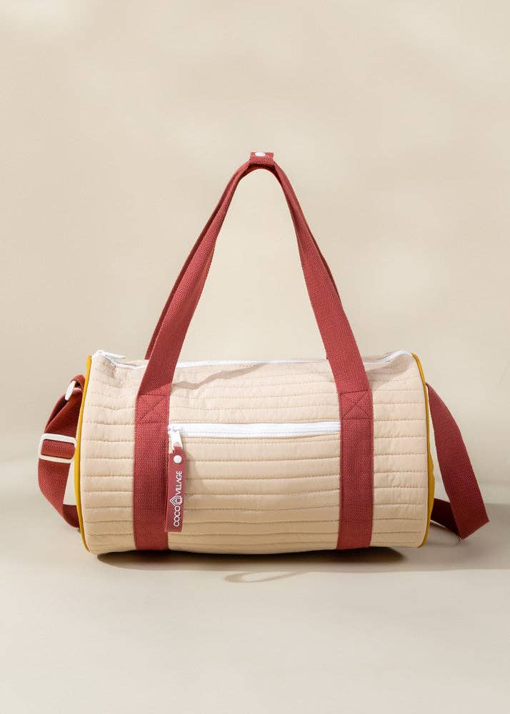Beige and red duffel bag on a beige background