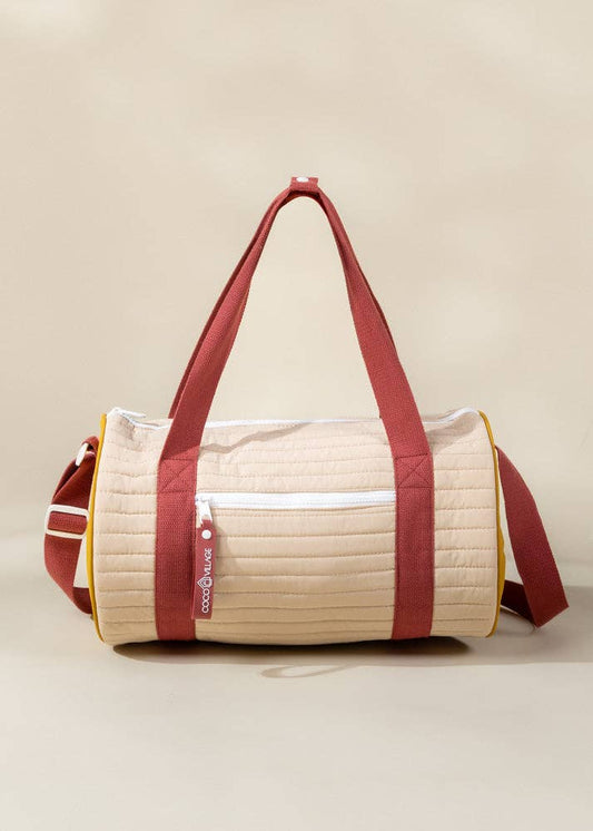 Beige and red duffel bag on a beige background