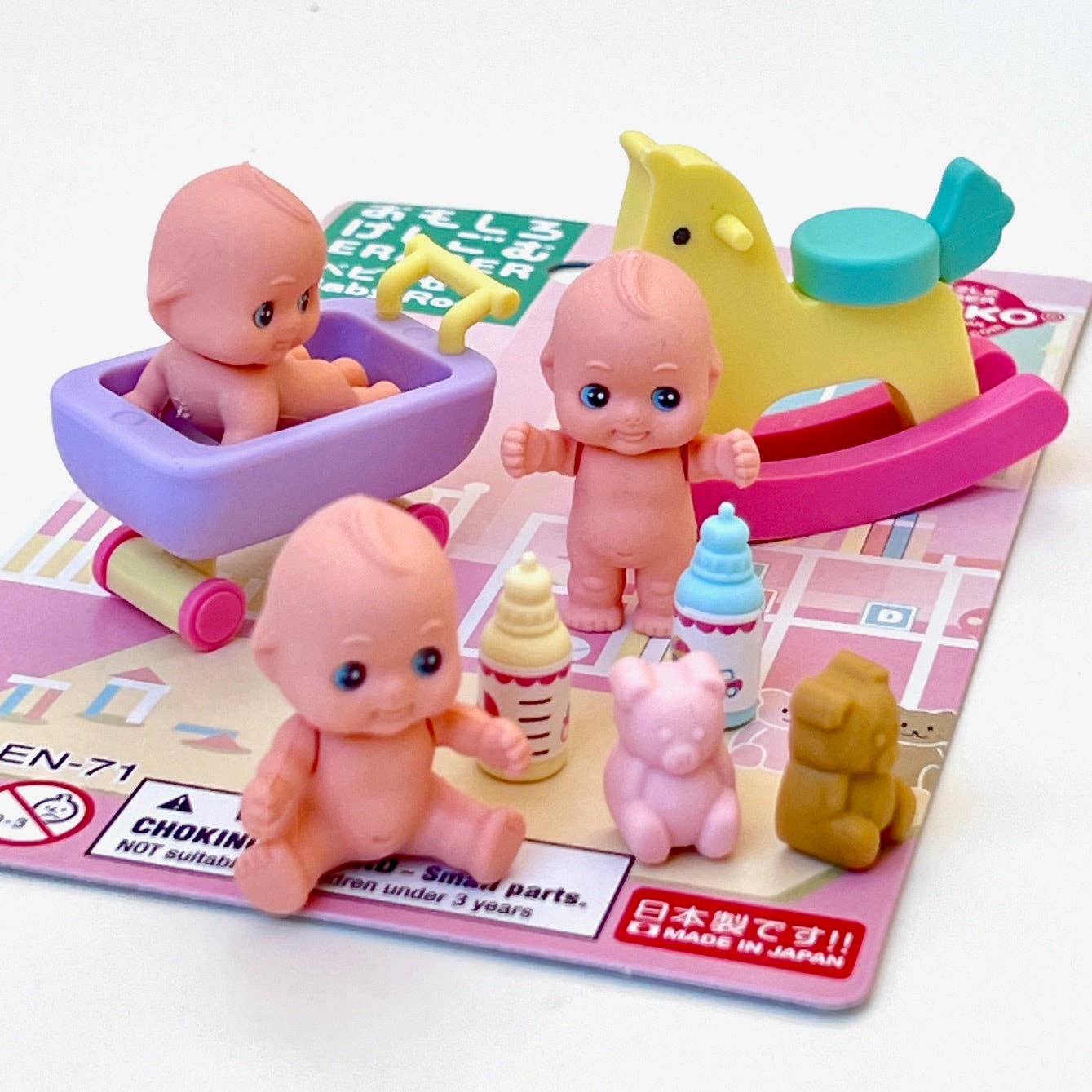 Eraser baby figurines with accessories on a colorful play mat