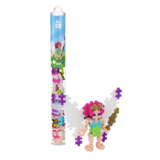 Puzzle fairy figure with colorful hair and accessories next to a cylindrical packaging tube on a white background