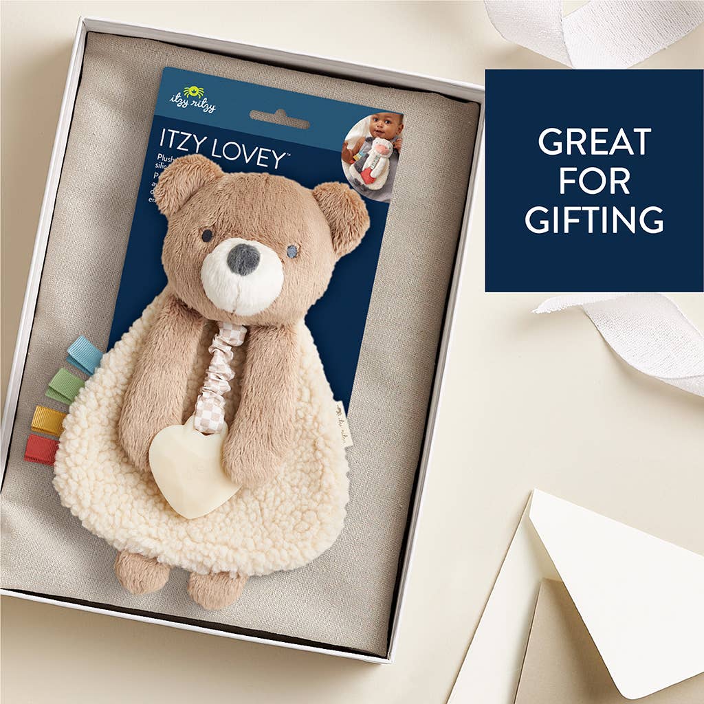 Teddy bear comfort toy with packaging in a box, labeled 'Itzy Lovey', on a light background.